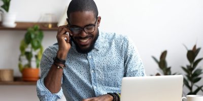 Man happy on the phone discussing work